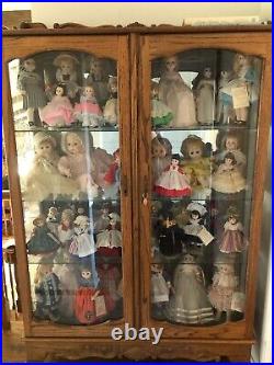 Madame Alexander Doll Collection with oak/etched glass curio cabinet. 44 dolls