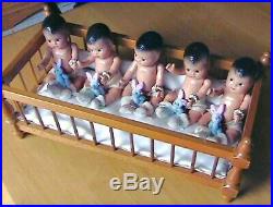 Vintage composition Dionne Quintuplets dolls with crib and nurse, 1930's
